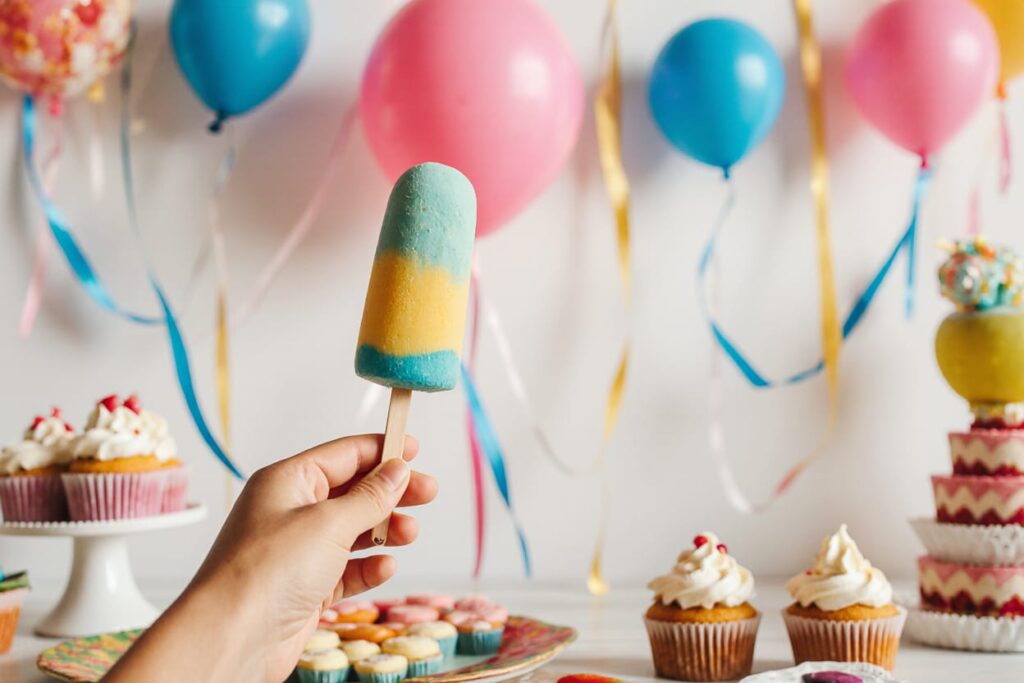 Assortment of decorated cake popsicles with various toppings